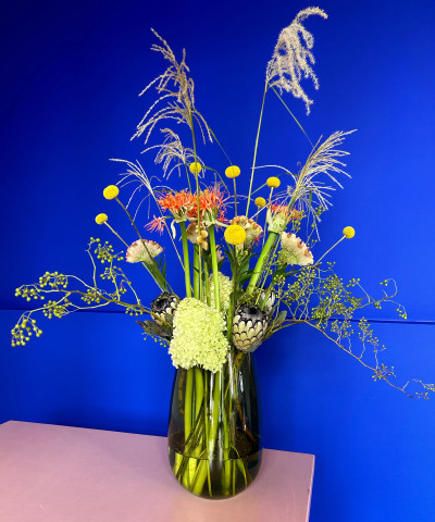 Blumenstrauß vor blauer Wand