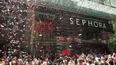 Große Menschenmenge vor dem Sephora Store, in der Luft schwebt Konfetti